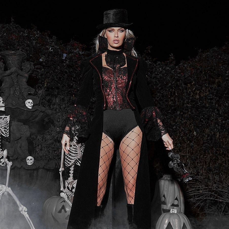 RaveFix 4pc The Lusty Vampire Costume Includes Long Coat with Flair Sleeves and Trim Detail on Collar and Built in Corset with Zipper Closure, Neckpiece, Shorts, & Top Hat